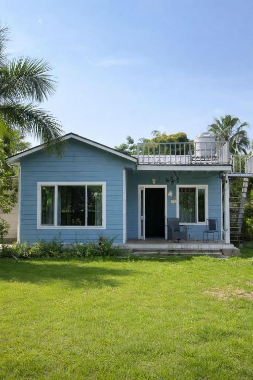 a blue house with a large yard at CASA NOVA Villa in Noida