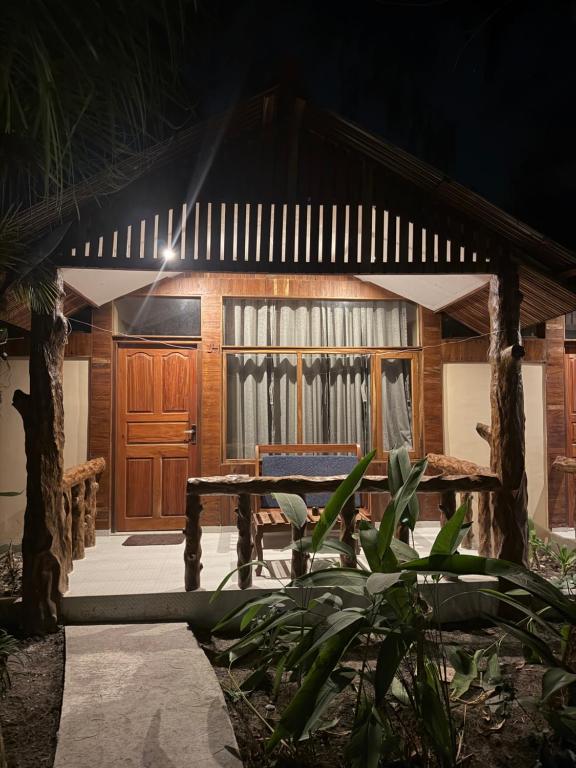 a wooden building with a table in front of it at Havelock Farms Resort in Havelock Island