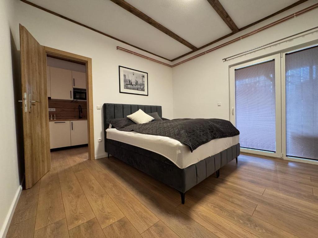 a bedroom with a bed and a large window at Apartman Bor in Kiseljak