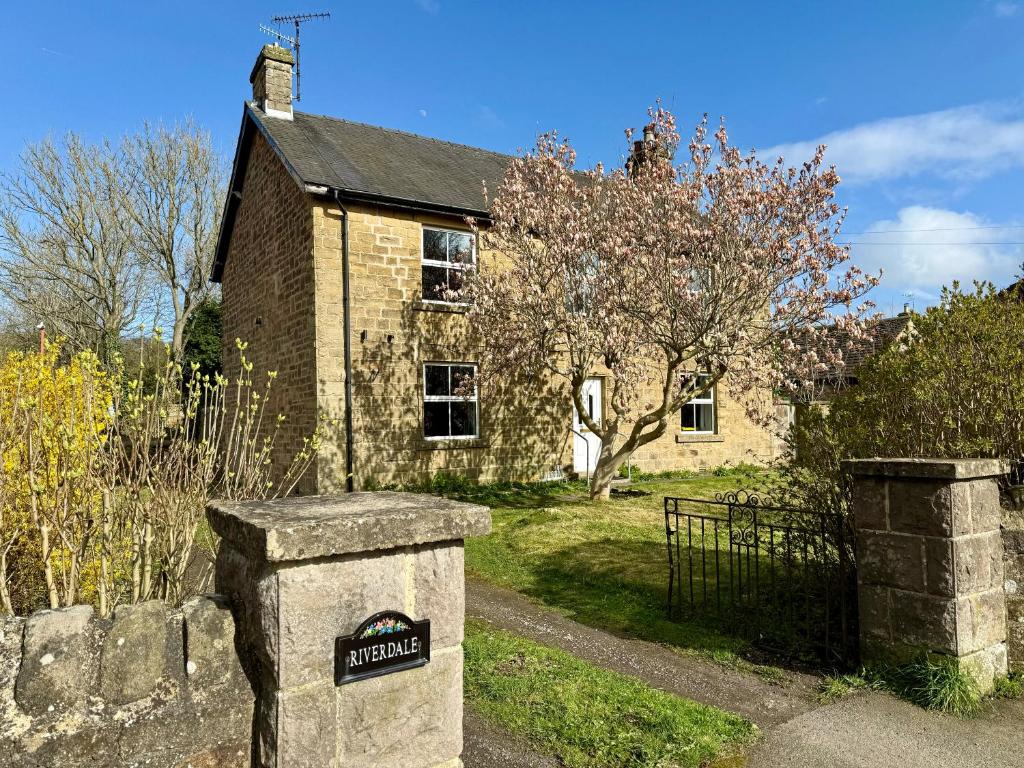 an old brick house with a sign in front of it at New! Luxury 4 Bedroom Detached House - Central Baslow in Baslow