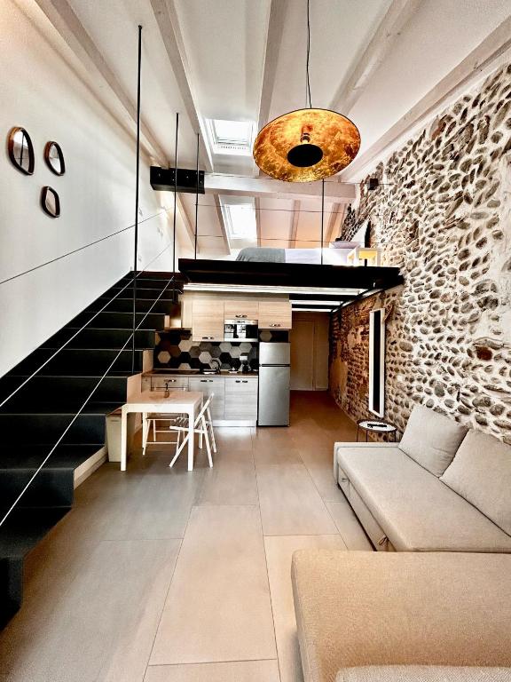 a living room with a staircase and a couch at Perla Loft in Seriate