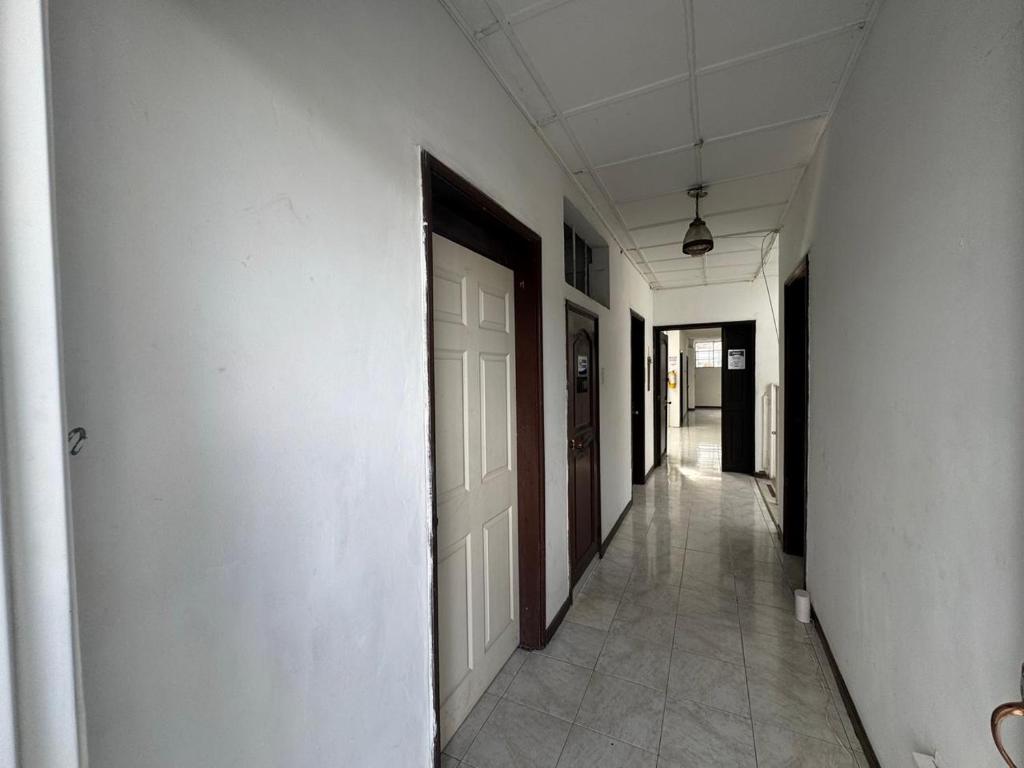 an empty hallway with white walls and a door at HOTEL ASL HOME CALI NORTE - Hospedaje AV 6A NORTE in Cali