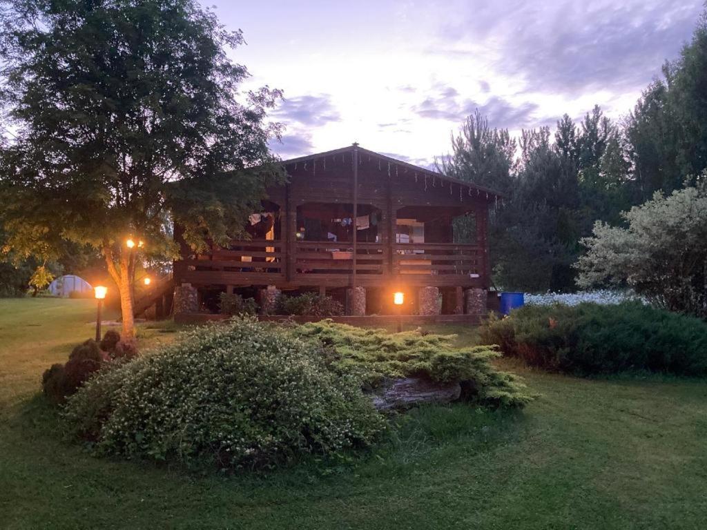 a large wooden cabin in a yard at night at Pikkjärve puhkemaja in Tilsi