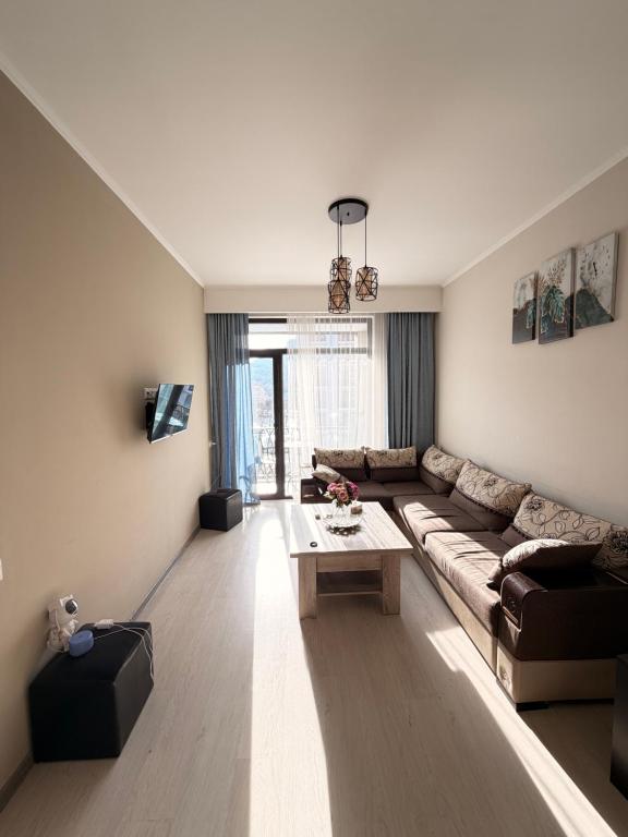 a living room with a couch and a table at Tsaghkadzor Alvina complex in Tsaghkadzor