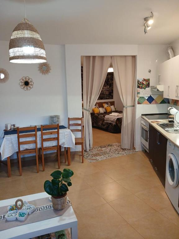 a kitchen and living room with a table and a dining room at El rincon de Adriana in Alquézar