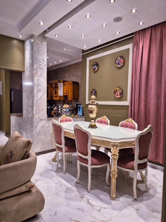 a dining room with a table and chairs at Galleria 1 in New cairo