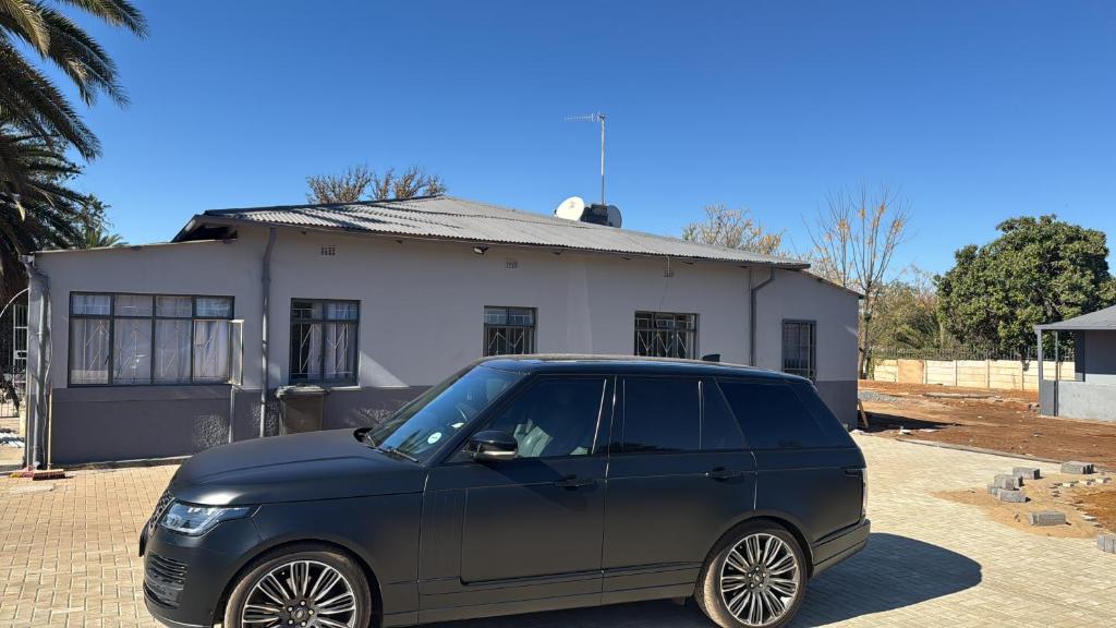 a blue car parked in front of a house at Albam residency kuruman in Kuruman