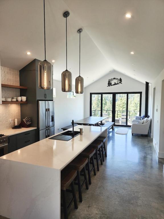 a kitchen with a large island in the middle of a room at Black Arrow Chalet in Courtenay