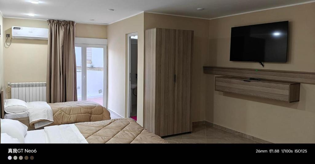 a hotel room with a television on a wall at Motel La Casbah in Constantine