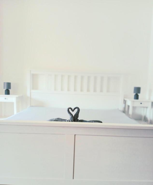 a white bed with a black ribbon on it at Palatinus Lake in Dorog