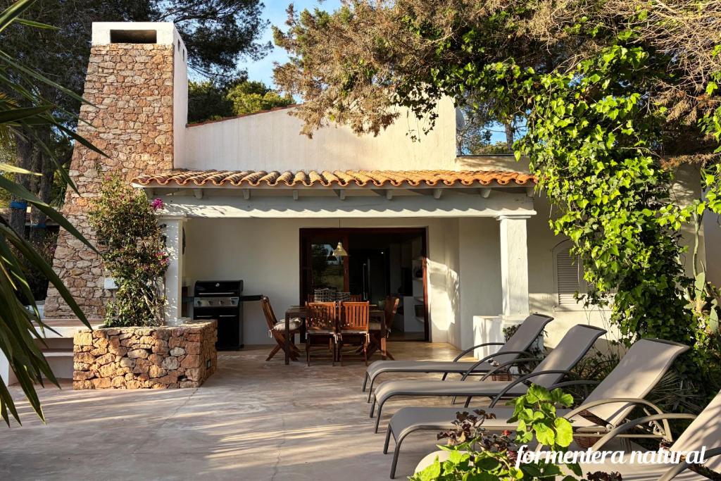 a group of chairs sitting on a patio at Casa Lilu Playa Migjorn - Formentera Natural in Playa Migjorn