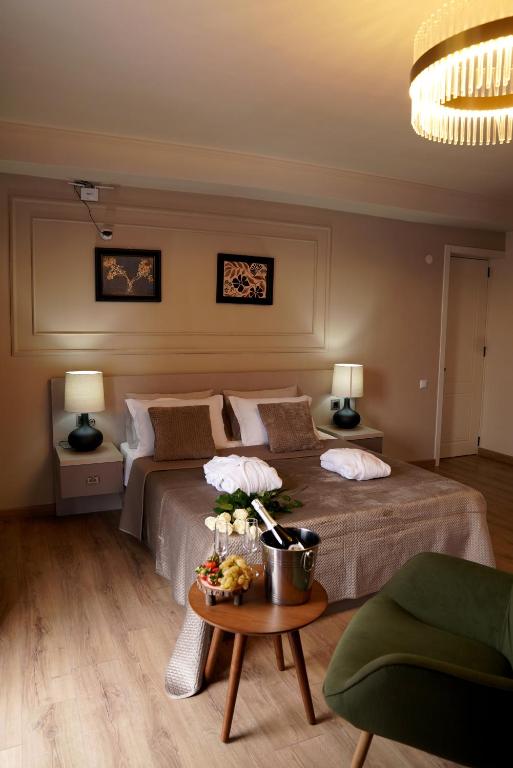 a bedroom with a bed and a table with flowers on it at EL hotel in Kutaisi