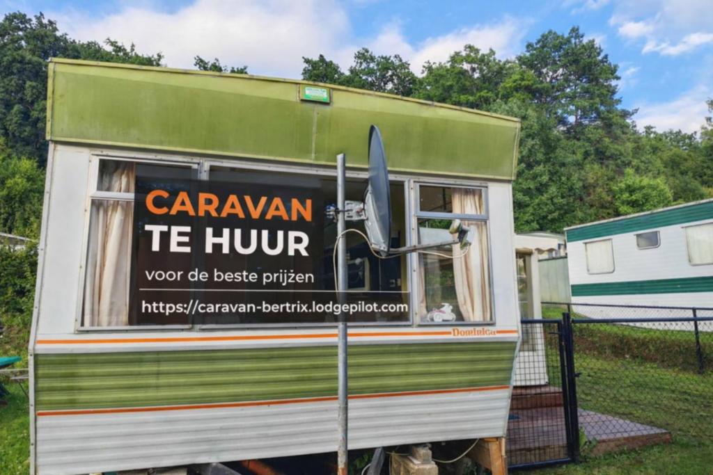 a green and white trailer with a sign on it at caravan hereumond in Cugnon