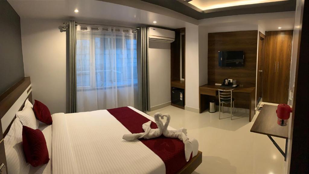 a bedroom with a bed with a stuffed animal on it at Shanti Regency in Guwahati