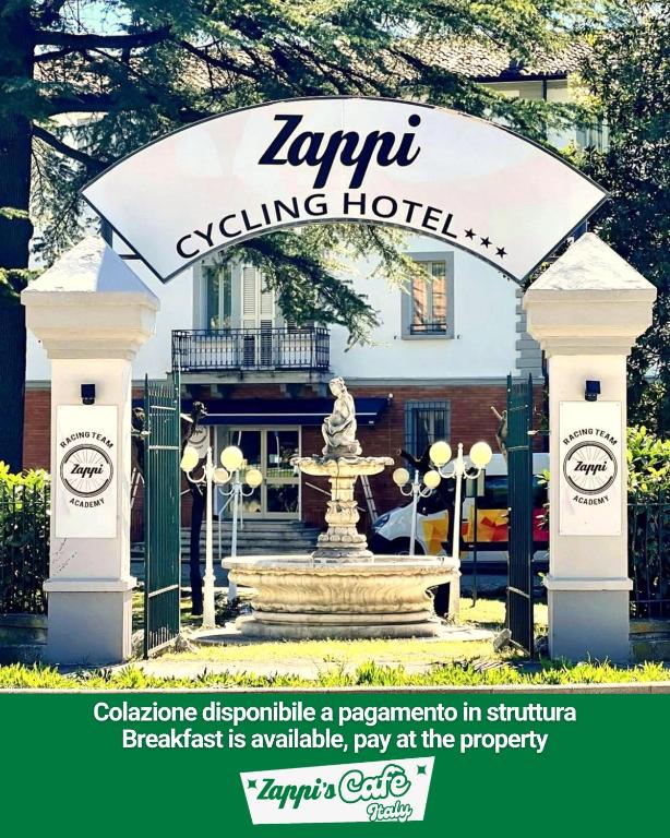 a hotel sign with a fountain in front of a building at ZAPPI CYCLING HOTEL in Riolo Terme