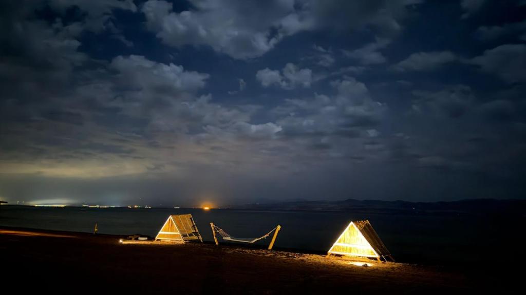 a couple of tents on a beach at night at Anne Nuweiba in Nuweiba