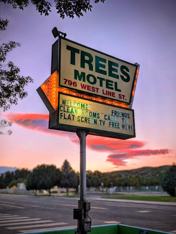 a tree motel sign on the side of a street at Trees Motel in Bishop