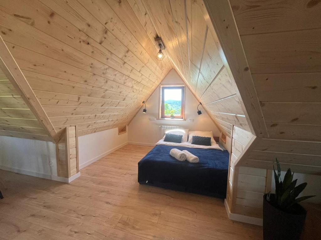 a bedroom with a bed in a attic at Kobakówka in Krynica Zdrój