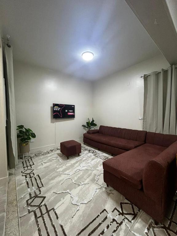 a living room with a couch and a tv at Terra Pyramids Hotel in Cairo