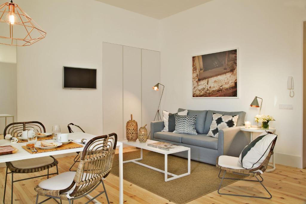 a living room filled with furniture and a table at Lisbon Five Stars Apartments Combro 77 in Lisbon