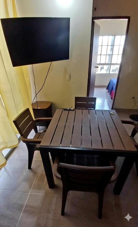 a wooden table and chairs in a room at Apartamento Paraiso Nuquí in Nuquí
