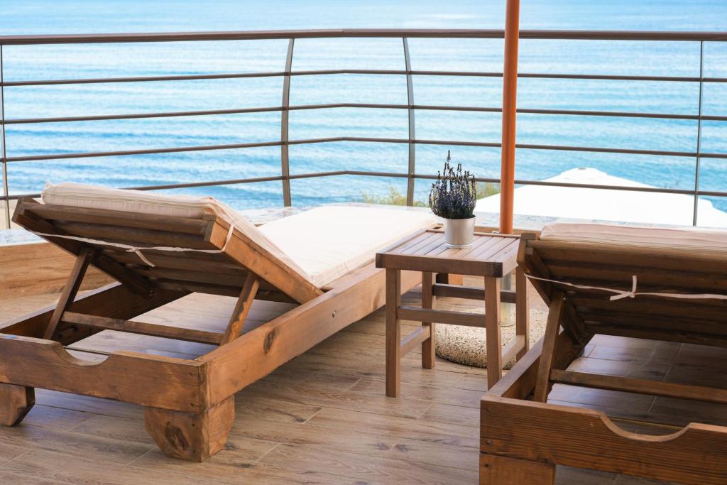 a room with a bed and a table on a ship at Aegean Balcony Apartment in Nea Peramos