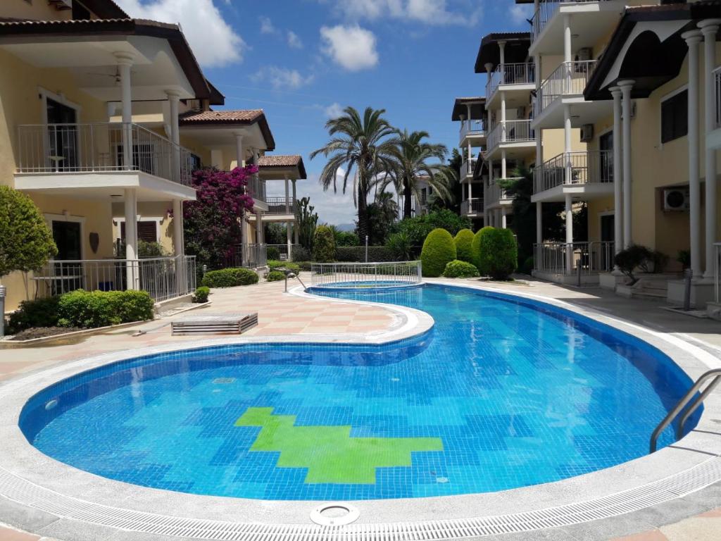 a swimming pool in front of some apartment buildings at Side Beach Villarında Dubleks Daire in Side