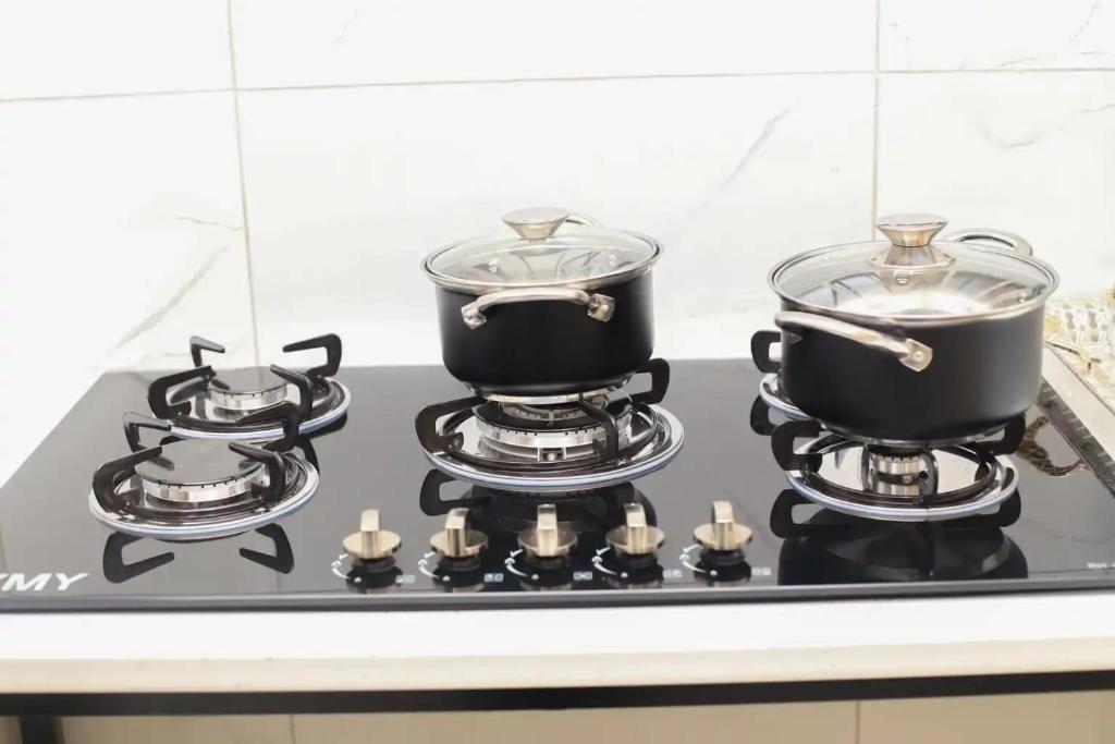 two pots and pans on a stove in a kitchen at Lagrande CBD in Benoni