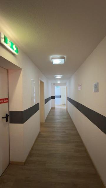 a hallway of an office building with a long corridor at Hotel Alden in Aldenhoven