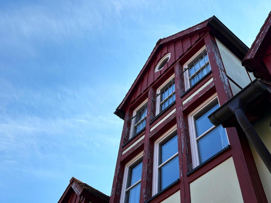a red building with windows on top of it at eXo Hotel Franka Bamberg - by NeVo Hotels in Hallstadt