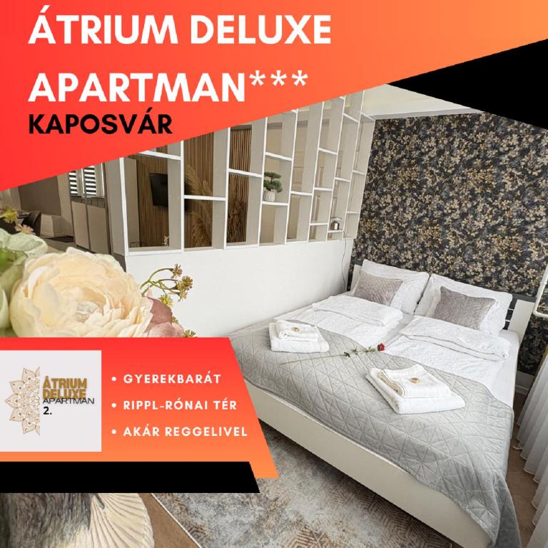 a poster for a bedroom in an apartment with a bed at ÁTRIUM Apartman Kaposvár in Kaposvár