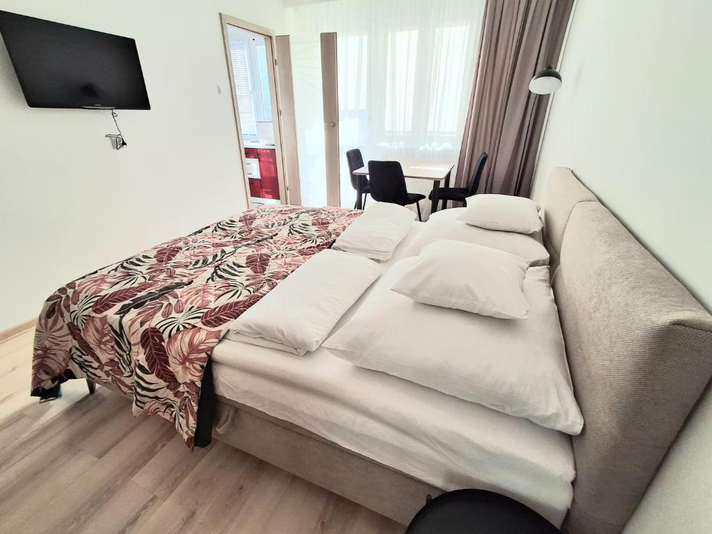 a bed in a hotel room with a couch at Apartament Bursztynowy in Ustka