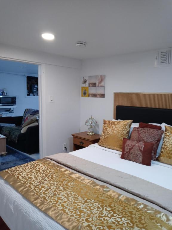 a bedroom with a large bed with pillows at "Cozy Basement Retreat Just 40 Minutes to NYC!" in Irvington