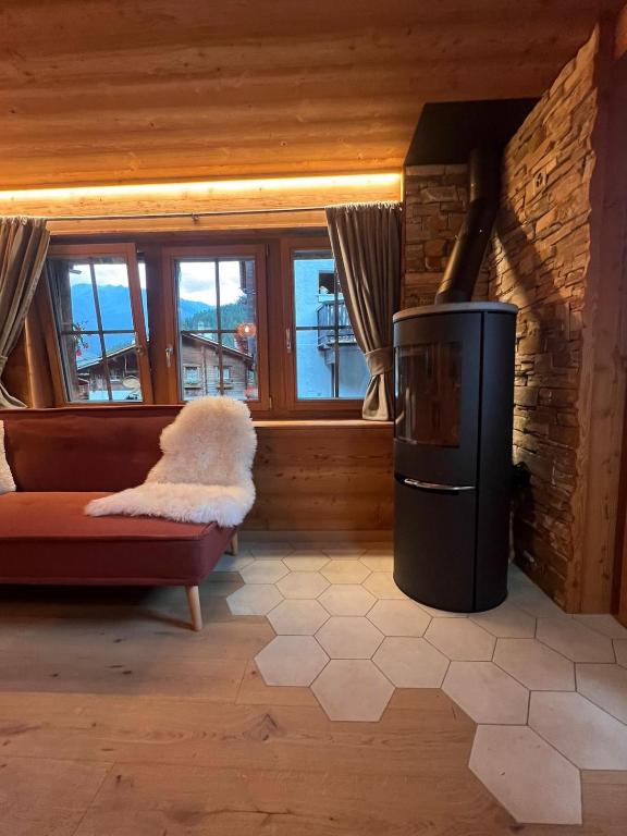 a living room with a couch and a trash can at La Grangette in Grimentz