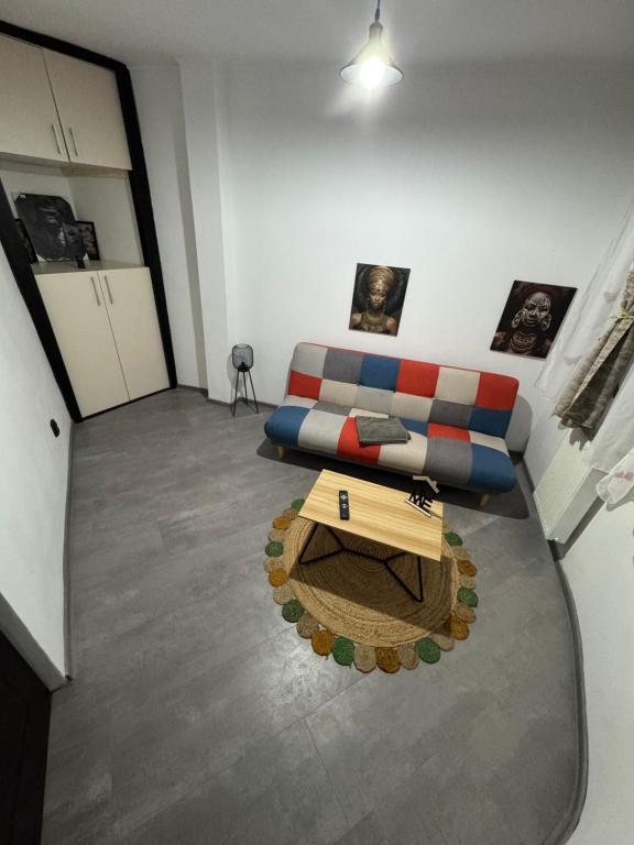 a living room with a couch and a table at HomeStars16 in Bîrlad
