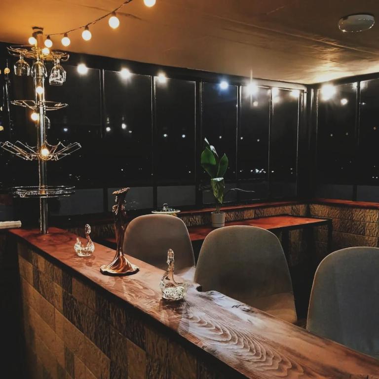 a dining room with a table and chairs at Brick House Melodies in Tsqaltubo