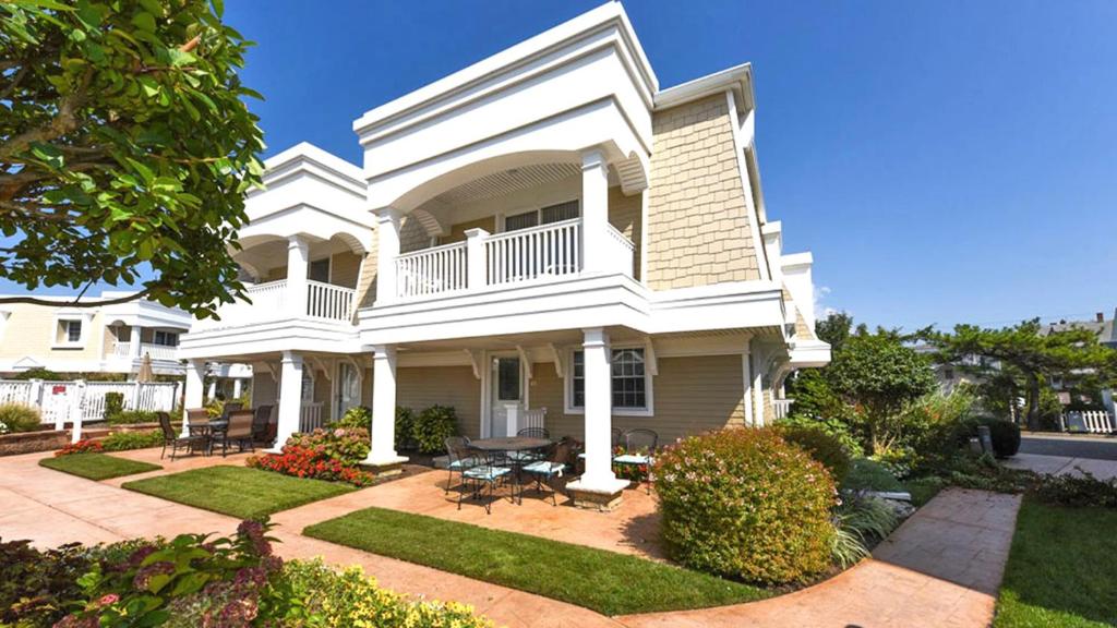 a white house with a porch and a patio at 215 Heritage Lane in Cape May