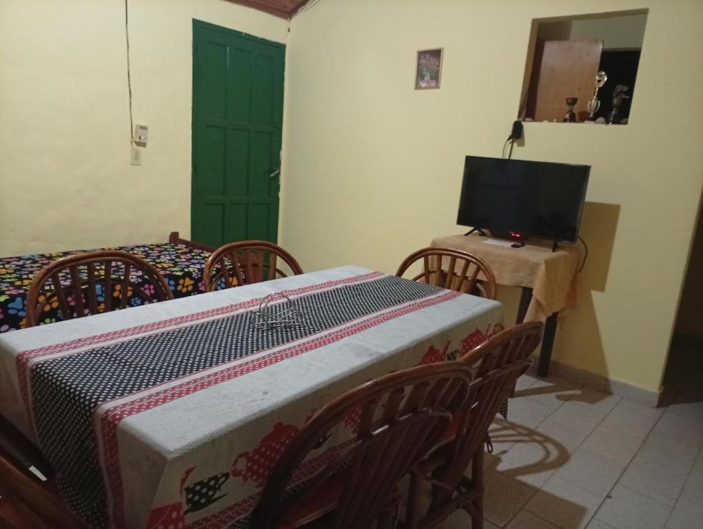 a room with a table with chairs and a television at Finca Re Mar 1 in Santa Ana
