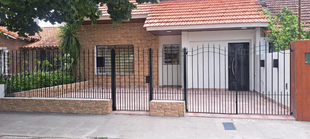 a gate in front of a brick house at Apartment for 2 people - Jorge One in Adrogue
