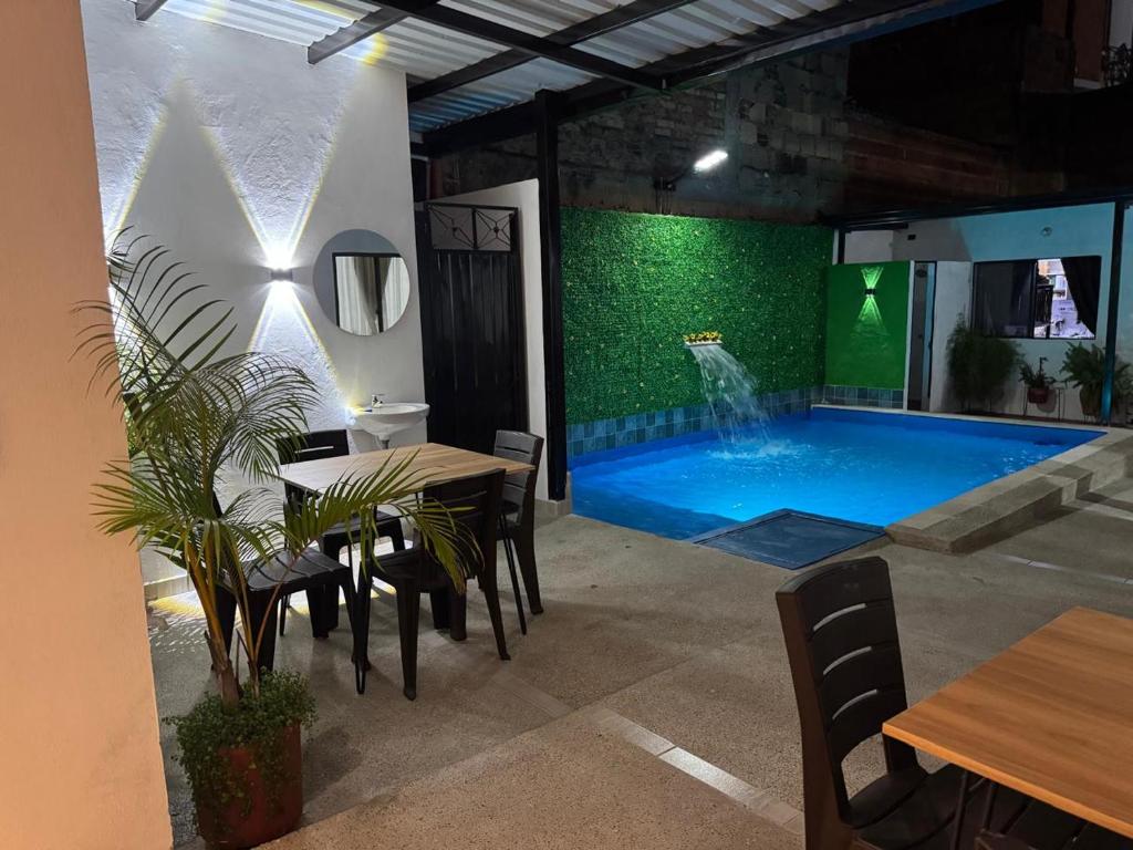 a large swimming pool in a room with a table and chairs at Tierra Dulce - Casa Turística in Villeta