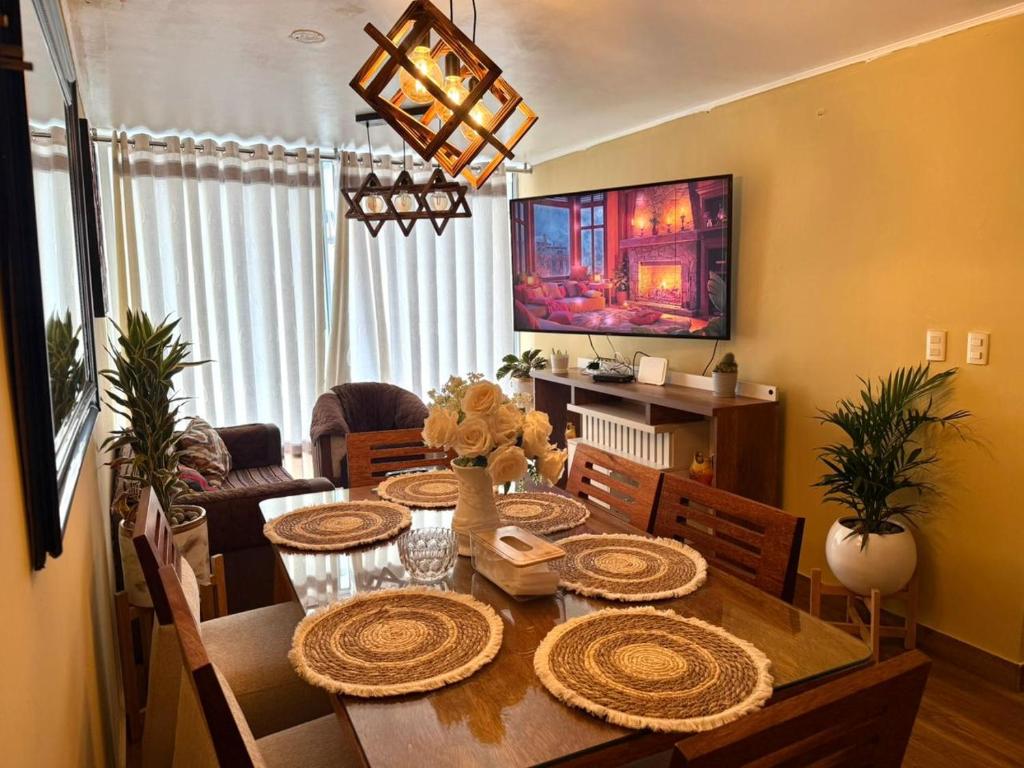 a living room with a dining room table with chairs at City Center Lima in Lima
