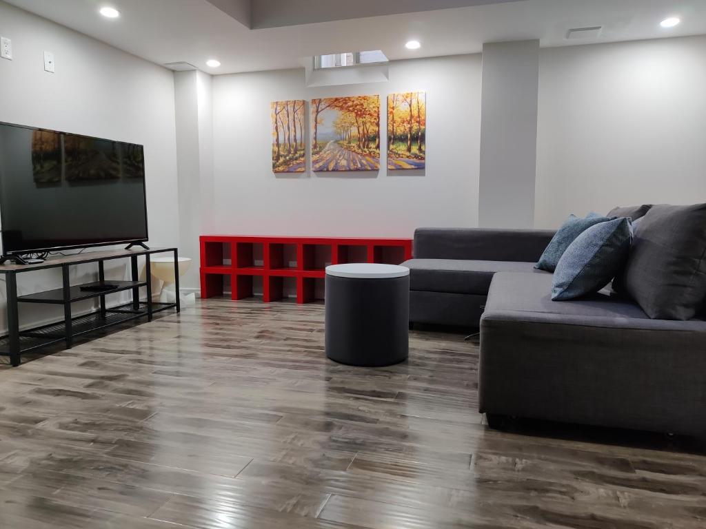 a living room with a couch and a flat screen tv at Suite! Separate Entry, 1 Parking in Newmarket