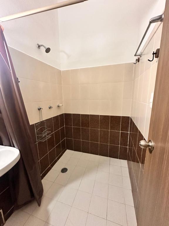 a bathroom with a shower and a sink at Casa Brisas in Puerto Escondido