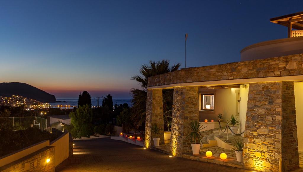 a villa with a view of the ocean at night at Skopelos Holidays Hotel & Spa in Skopelos Town