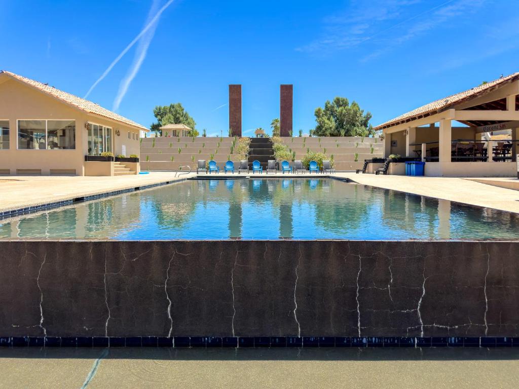 a swimming pool in front of a building with a fountain at Stylish Condo Beach & Pool Access E202 in Puerto Peñasco