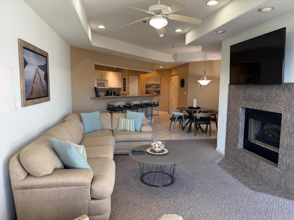 a living room with a couch and a fireplace at Lake Ozarks Get Away Topsider in Lake Ozark