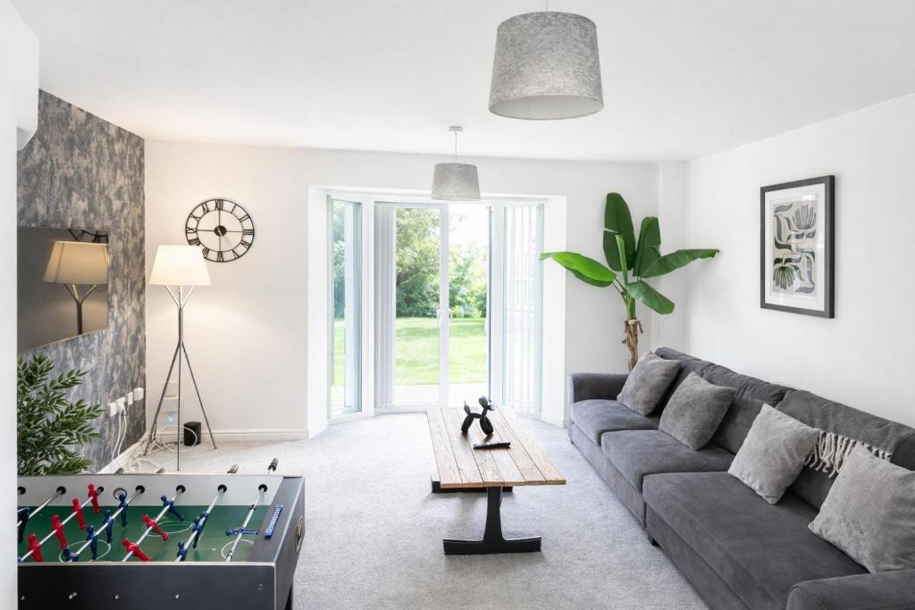 a living room with a couch and a foosball at 3-Bedrm, Parking, Soccer Table, Sleeps 7 in Cannock