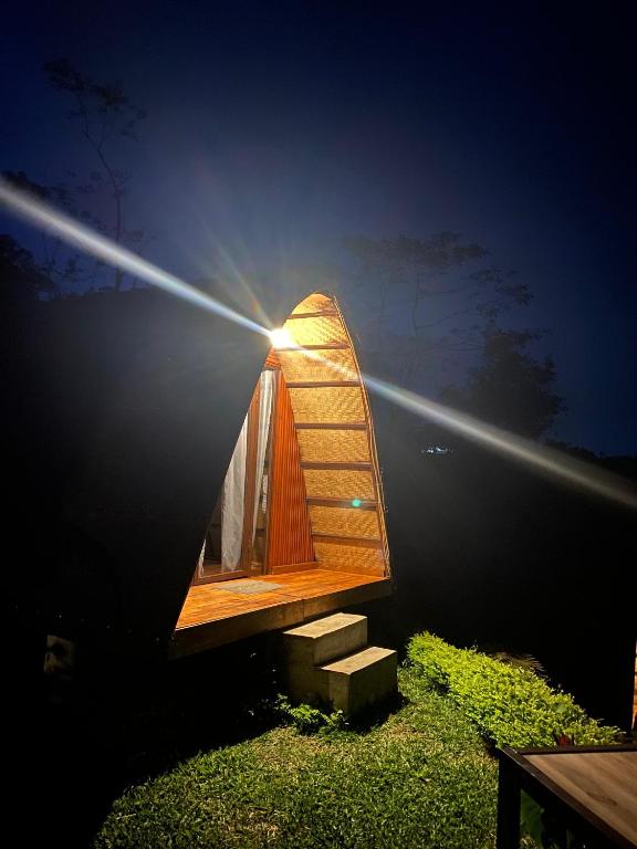 a tiny house with the sun shining behind it at Giri Garden Sunset Glamping in Gitgit