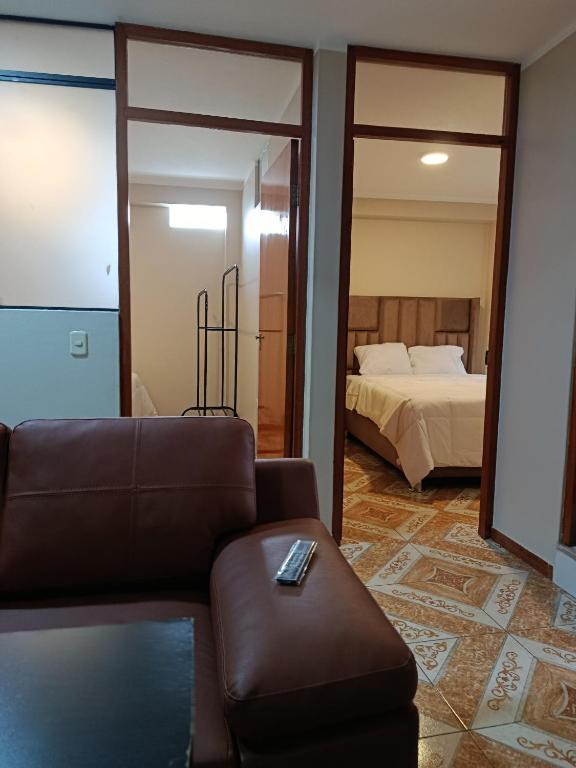 a living room with a couch and a bed at Allin Samay in Ayacucho