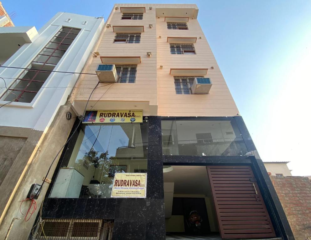 a building with a sign on the side of it at Rudravasa Inn in Varanasi